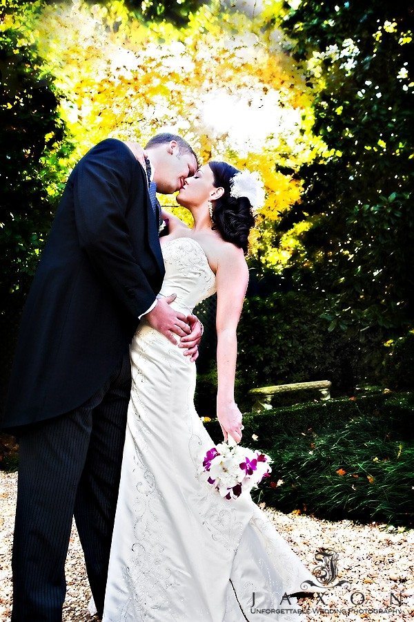 Groom kisses his new wife in the gardens at Flint Hill | congratulations robin