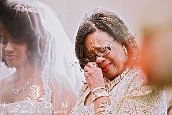 Mother of the bride sheds a tear as she escorts her daughter in the wedding ceremony | Eagle's Landing Country Club