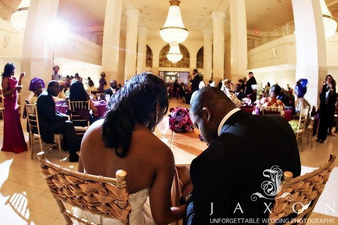 Newly wed couple prays before their meal in the Grand Atrium at 200 Peachtree