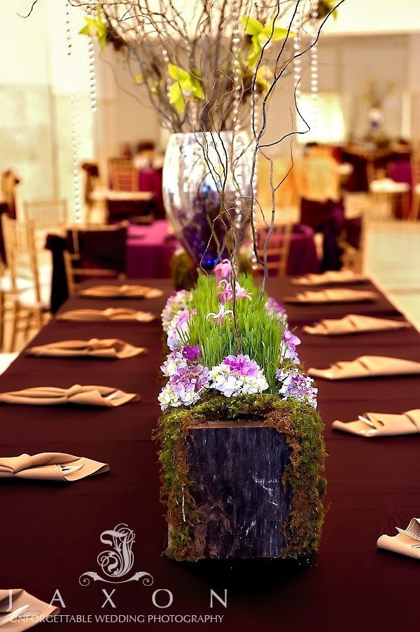 Burgundy and gold Table scape, decorated with green moss covered wooden boxes containing grass, purple and lavender flowers, call lilies and twigs at their 200 peachtree atlanta wedding