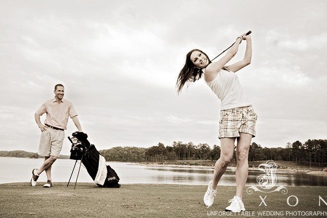 She swing at the golf ball while he looks on 