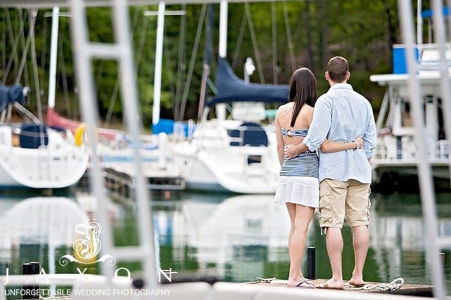 Couple embrace looking at the yachts at the docks at Lake Lanier Islands