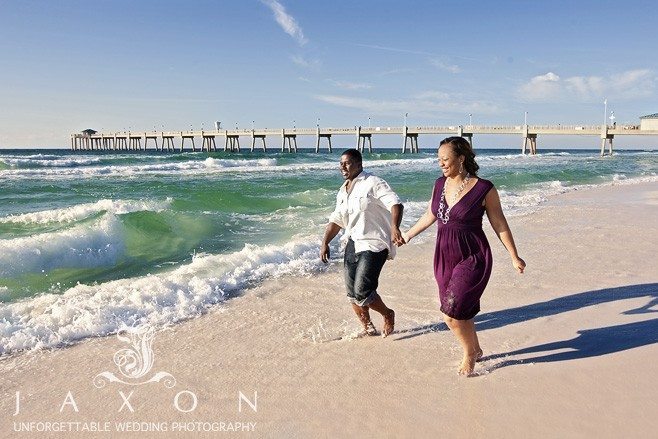 Fun portrait of engaged couple running on beach | beach engagement session