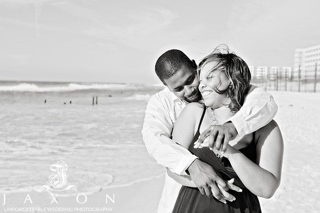 Romantic B&W portrait of African american couple on beach during their engagement portrait session | beach engagement session