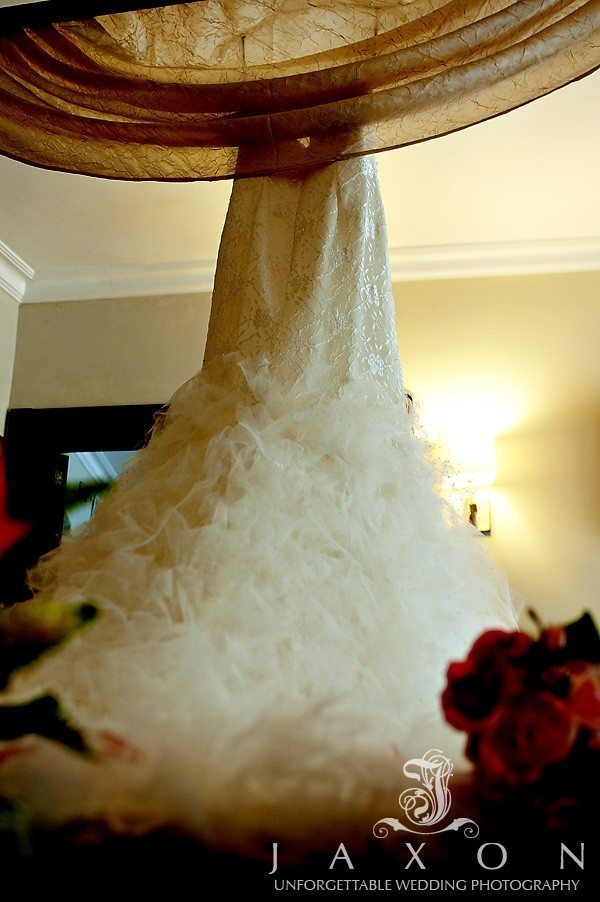 Brides dress hanging in bridal suite 