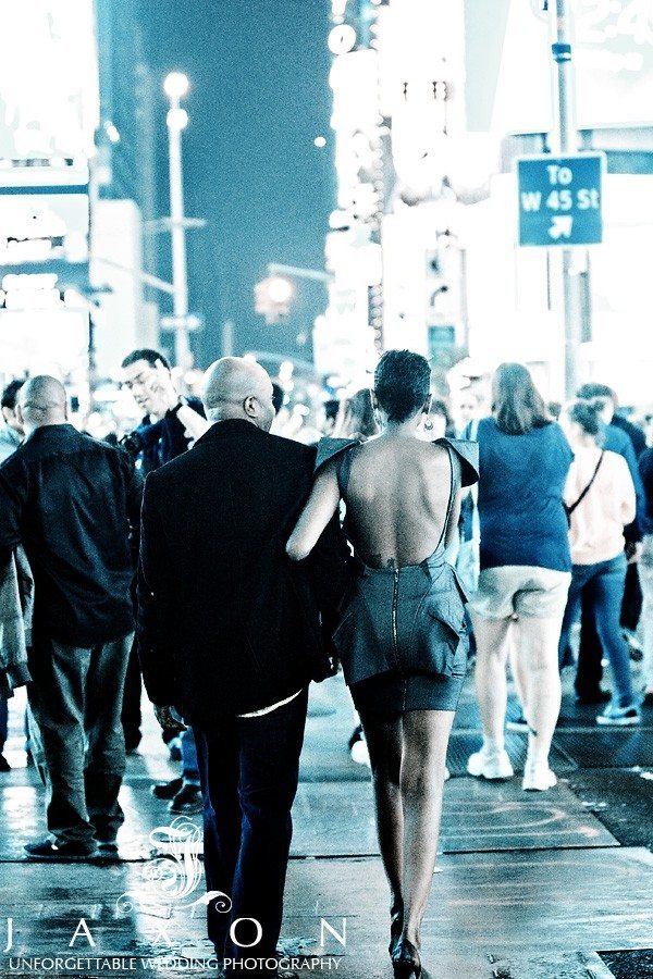couple strolls thru Times Square 