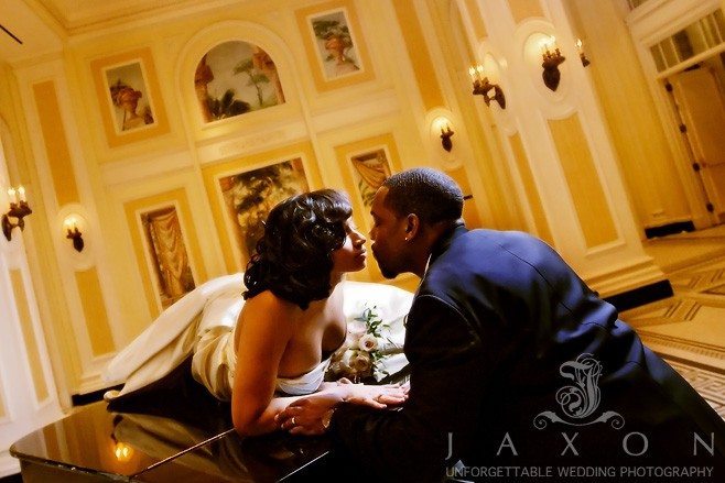 Stolen Kiss on the piano at their Georgian Terrace Hotel Wedding, Atlanta