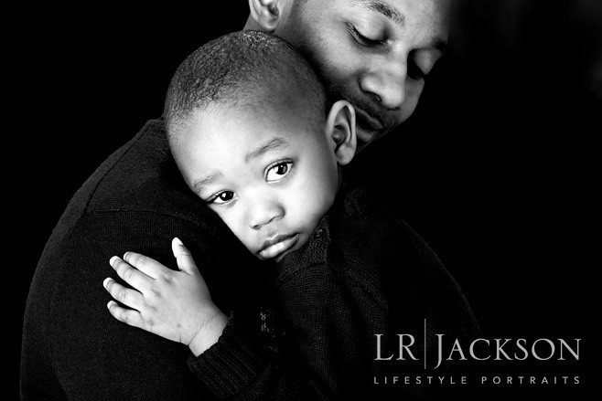 Dad holds is toddler close during this family and lifestyle portraits session,