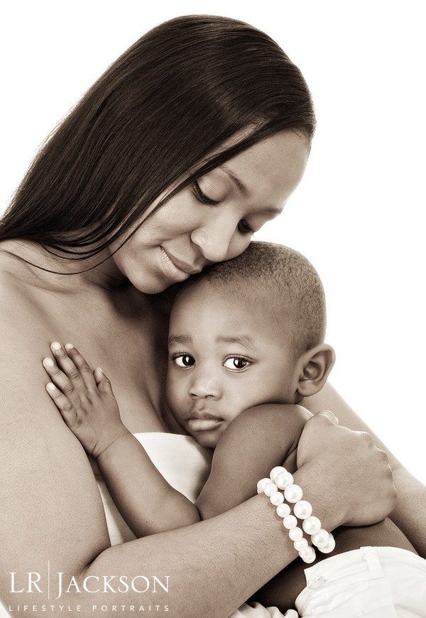Mom cuddles and comforts her toddler son during the family and lifestyle portrait session