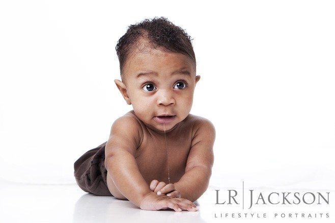 6 month african american baby boy shirtless against a white background in studio