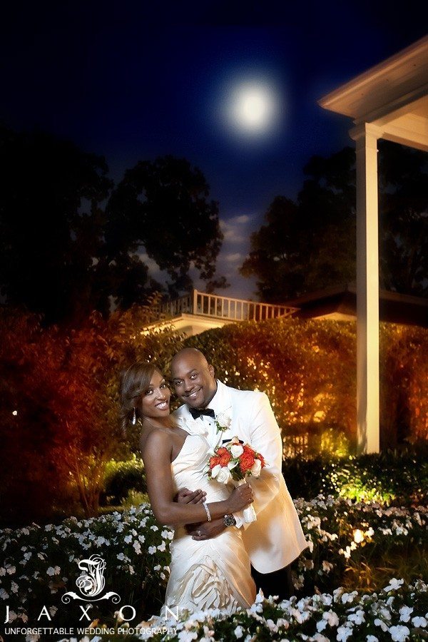 In this night time photograph the Bride and groom in the garden as the moonrises in the background | Flint Hill Wedding 