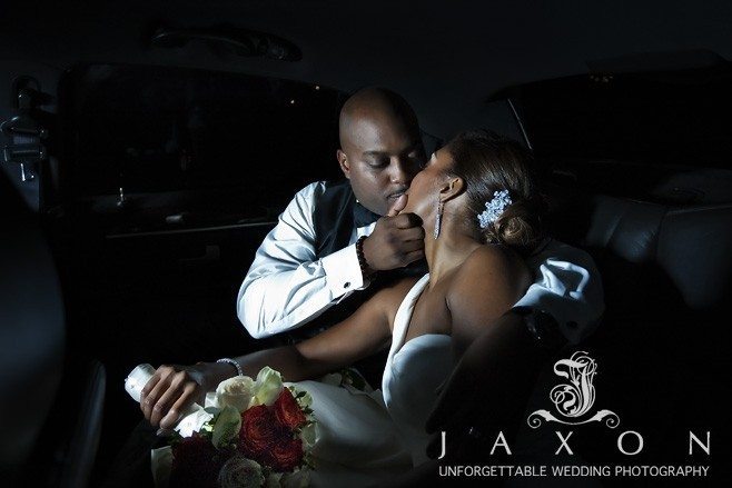 Couple shares a kiss in their limo | Flint Hill Wedding