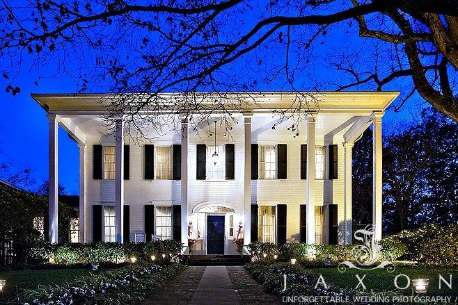 The impressive Flint Hill Mansion lit at twigh-light against a dramatic purple sky |Flint Hill Wedding