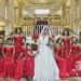 Bride and her party of 9 in strapless floor length burgundy dress in the lobby of the Augusta Marriott at the Convention Center