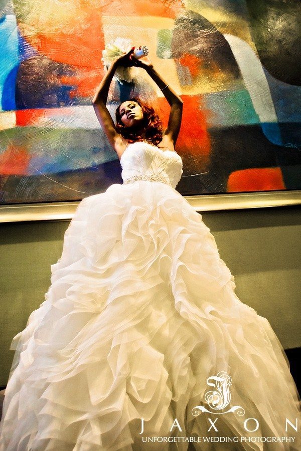 Sexy fashion oriented shot of the bride against a big painting in hallway | Atlanta Airport Marriott