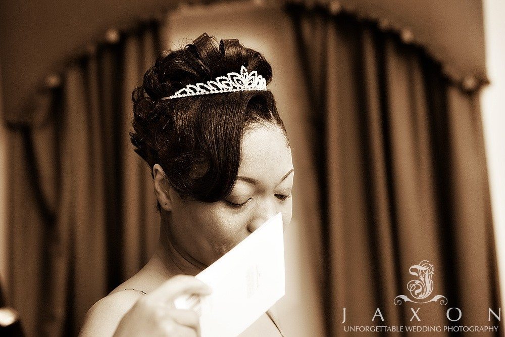 Bride gets teary eyed as she reads a card from the groom | Eagles Landing Wedding