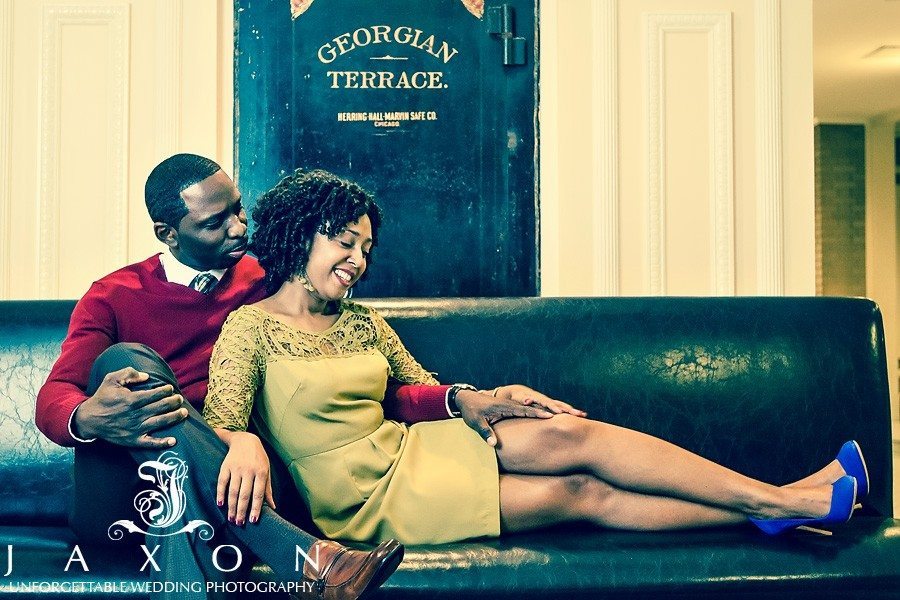 couple on a vintage couch in the cellar at their Georgian Terrace hotel engagement session