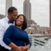 Couple on the roof top at the Glenn Hotel with Atlanta City skyline as backdrop