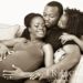 Husband, daughter and expecting mother in family portrait, sepia toned image of African American Family