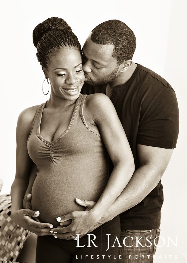 Sepia toned portrait of expecting couple