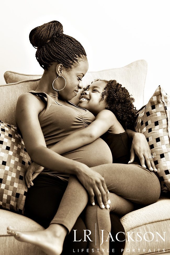 A tender moment between mother and daughter in this black & white portrait 