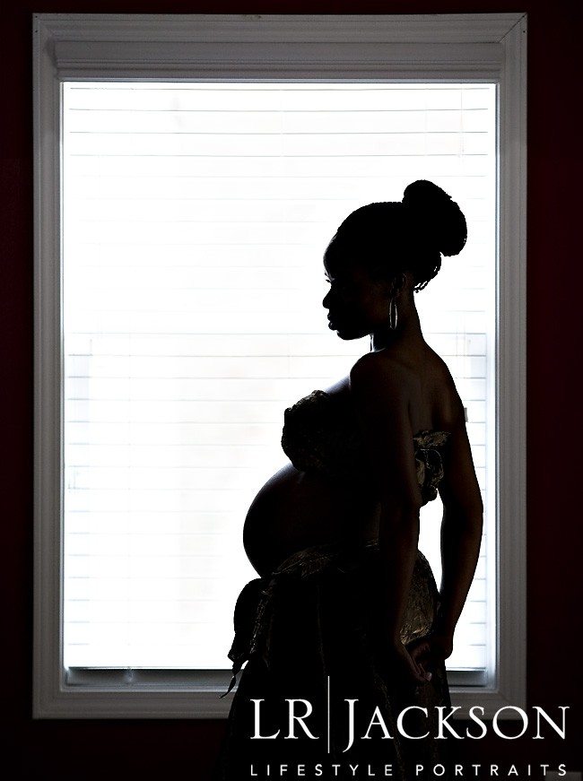  Maternity Portraits | silhouette of pregnant woman, framed in window opening