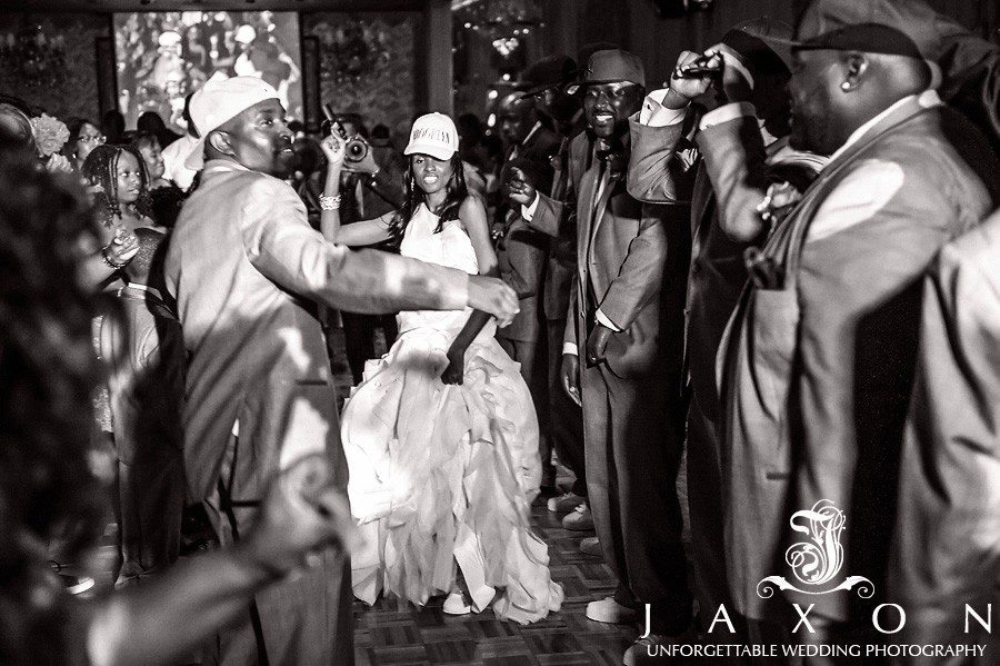 Bride and groom don their white baseball caps emblazoned with the tag Brooklyn and parties with the wedding party | Riviera Wedding Brooklyn, NY