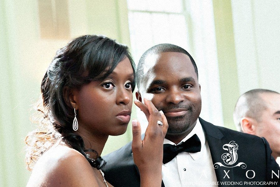 A teary emotional bride listens to her father's speech at the wedding reception