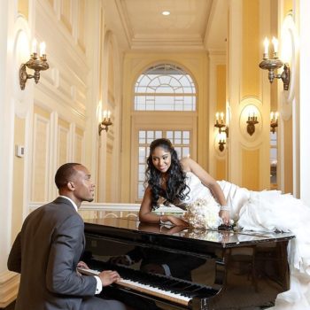 Groom plays his new bride a tune as she lays on Baby Grand Piano in the Piedmont Foyer