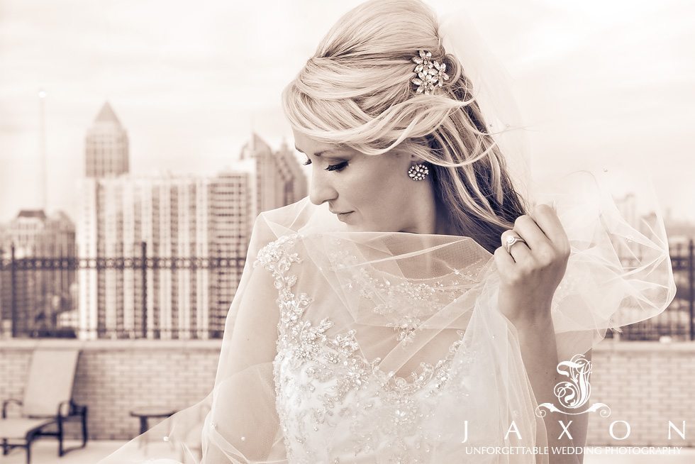 Sepia Portrait on the roof of the luxurious Georgian Terrace Hotel with cluster of three six petal broach and diamond cluster earring