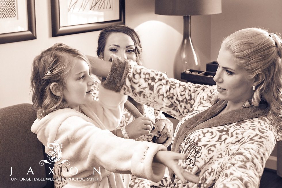 Bridesmaids and flower girl share an embrace in the bridal suite at Georgian Terrace Hotel Atlanta