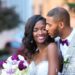 Bride and groom in tender embrace at hurt plaza in-front of the venetian room