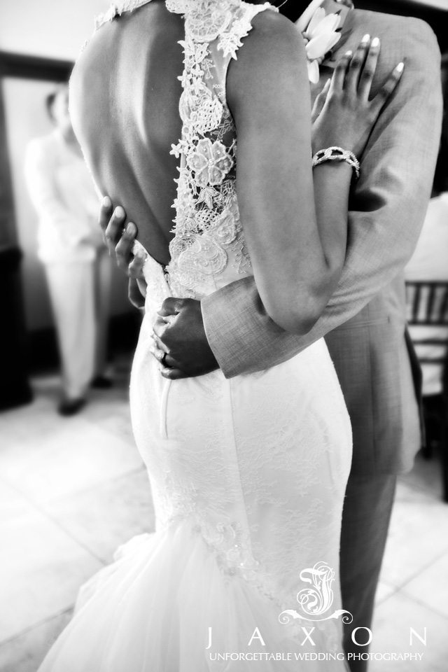 Photo highlighting the floral embroidery pattern surrounding the heart shaped cutout on back of bride’s dress