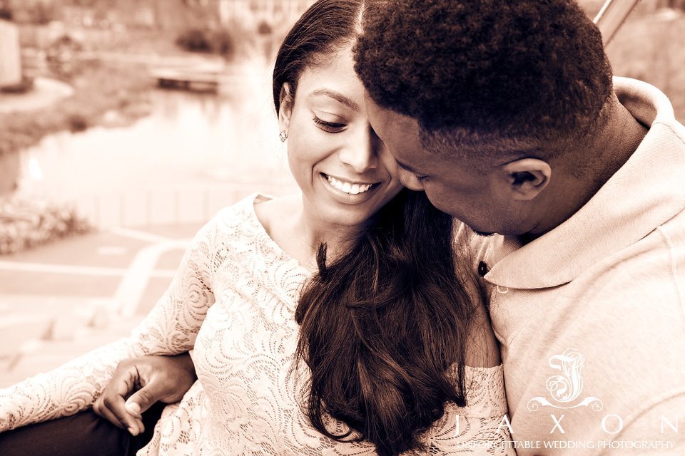 Sepia tone portrait of couple embracing on steps during Historic Old Fourth Ward engagement session