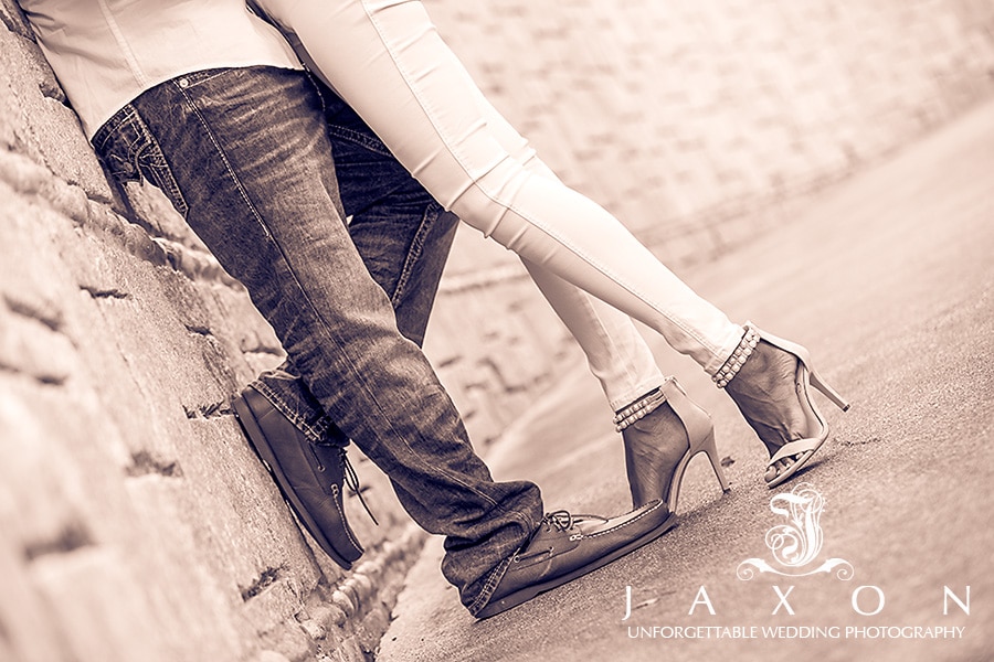 Sepia image of embracing couple's feet