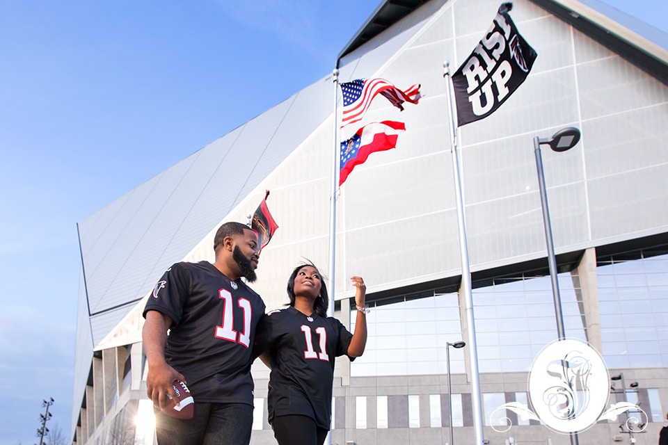 Engaged couple wearing the #11 Falcons jersey 