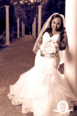 Sepia toned portrait of bride in the garden at Vines Mansion