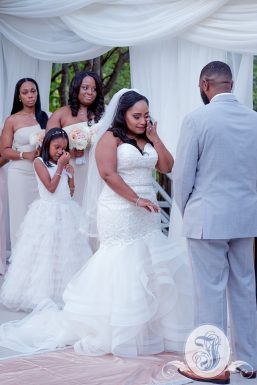 Emotional bride and daughter during vows