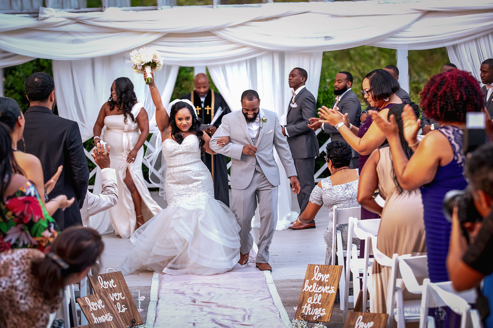 bride triumphantly thrusts her hand in the air