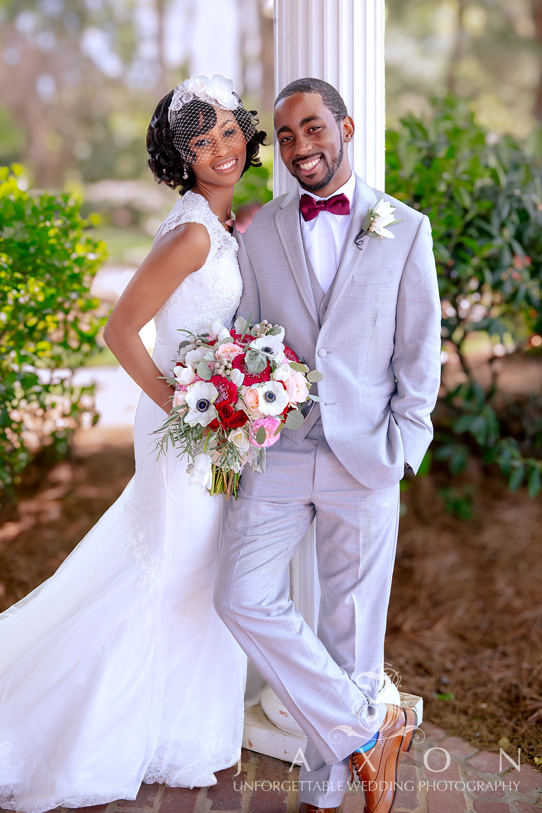 Bride and groom in elegant attire leaning against a column, Carl House, Atlanta