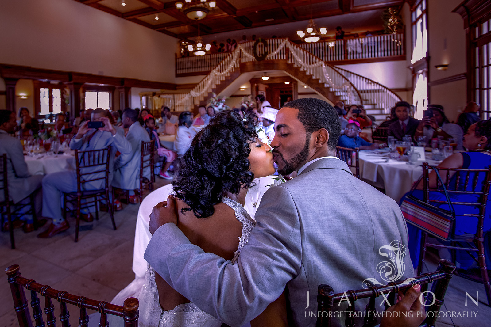 Couple shares a kiss in the grand ballroom at The Carl House in Atlanta