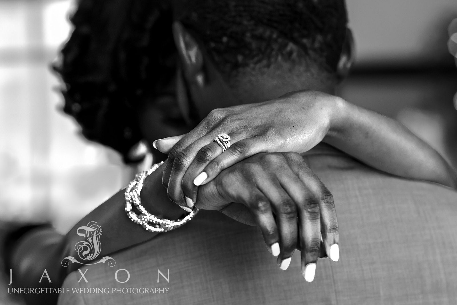 Close-up of bride's ring and link chain bracelet during first dance at Carl House Wedding